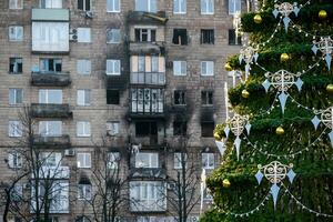 Natal árvore com brinquedos perto a casa dentro a arruinado cidade dentro Ucrânia foto