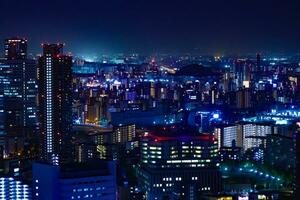 uma noite paisagem urbana de Alto ângulo Visão perto Kyocera cúpula dentro Osaka foto