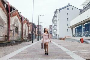 jovem bonita empresária caminhando dentro a Avenida em a arredores foto