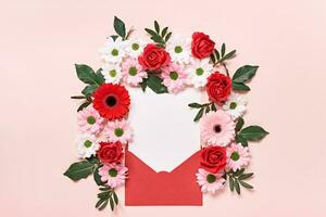 vermelho envelope com romântico amor carta brincar e flores em Rosa fundo foto