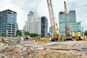 Alto subir construção debaixo construção. instalação do vidro fachada painéis em uma reforçado concreto estrutura. foto