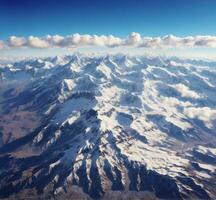 ai gerado aéreo Visão do Himalaia montanha alcance com nuvens e azul céu foto