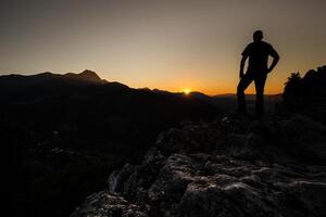 caminhante em uma montanha topo às pôr do sol. mulher admirando montanha panorama dentro Alto tatra montanhas, Polônia. foto