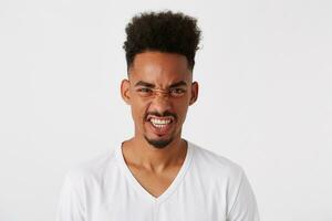 retrato do louco furioso africano americano jovem homem com afro Penteado desgasta t camisa foto