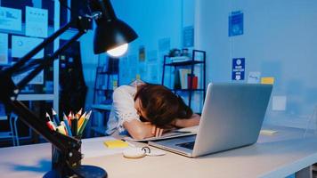 freelance asia exausto senhora trabalho duro dormindo no novo escritório em casa normal. trabalhar a partir da sobrecarga da casa à noite, remotamente, auto-isolamento, distanciamento social, quarentena para prevenção do vírus corona.