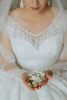 a noiva detém a do noivo flor dentro dela mãos. Casamento flores foto