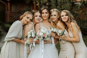 grupo do lindo mulheres dentro idêntico vestidos sorridente, a comemorar e tendo Diversão junto. amigos do a noiva comemoro a Casamento juntos com a noiva dentro natureza foto
