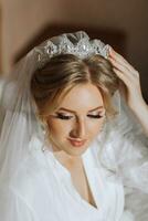 luxo Casamento coroa diadema em da noiva cabeça Penteado. manhã Casamento preparação noiva com coroa fechar acima foto