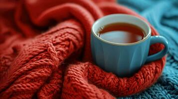 ai gerado azul copo do chá em uma vermelho tricotado cachecol dentro a azul café foto