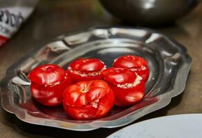 arranjo do recheado tomates com fresco hortelã folhas em metal bandeja dentro cozinha foto