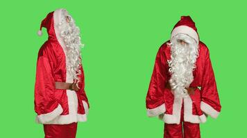 jovem homem dentro santa claus terno dizendo não posando sobre tela verde pano de fundo, agindo descontente enquanto ele desgasta tradicional inverno fantasia. negativo pessoa dentro santo usuario cosplay, desapontado papai noel. foto