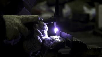 ferro Soldagem com brilhante luz e fumaça às fabricação. grampo. industrial trabalhador homem às a fábrica Soldagem fechar acima de arco foto