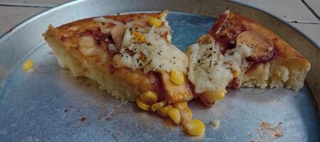 milho pizza fatia com queijo e linguiça foto