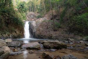 chae filho cascata fluindo baixa uma íngreme rochoso colina. primeiro nível cascata. raso piscinas e rochas, cercado de exuberante verde florestas. às chae filho nacional parque tailândia. foto