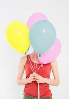 menina jovem com balões coloridos, isolados no fundo branco. copie o espaço foto
