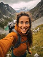 ai generativo jovem mulher levando selfie retrato caminhada montanhas feliz caminhante em a topo do a penhasco sorridente às Câmera viagem e passatempo conceito foto