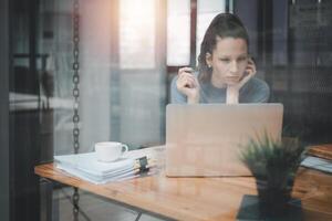 sério ocupado jovem o negócio mulher Gerente executivo olhando às computador portátil computador pensando do financeiro digital mercado riscos, considerando Novo corporativo estratégia ideia, assistindo webinário. foto