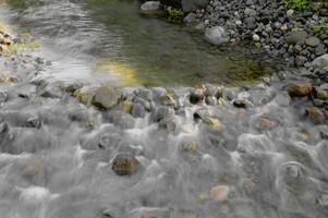 água fluxo a partir de pequeno corrente foto