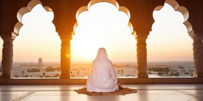 ai gerado muçulmano mulher Rezar dentro a mesquita às pôr do sol. Ramadã kareem foto