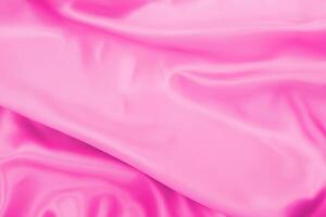 fundo de desfoque suave de textura de tecido de cetim rosa plástico foto