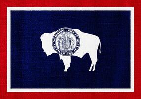 bandeira do Wyoming EUA Estado em uma texturizado fundo. conceito colagem. foto