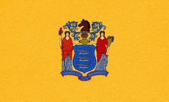 bandeira do Novo jérsei Estado EUA em uma texturizado fundo. conceito colagem. foto