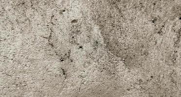 textura de cimento rachado cinza para segundo plano. arranhões na parede foto