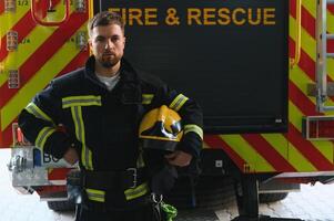 bombeiros homem dentro uma protetora terno perto fogo caminhão. proteção, resgate a partir de perigo. fogo estação foto