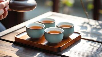 ai gerado tradicional chá cerimônia com porcelana copos em de madeira bandeja foto