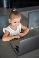 pequeno menina aluna conectados aprendizado, classe estude conectados vídeo ligar com professor em a computador portátil lar. distância Aprendendo conceito. foto