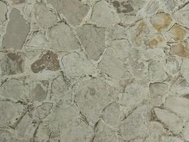 Castanho creme pedra parede textura que é geralmente instalado em a paredes do casas ou luxo vilas foto