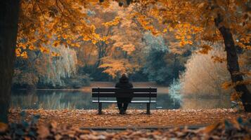 ai gerado depressão velho homem sentado em uma outono parque Banco com a calma águas do uma lago. foto