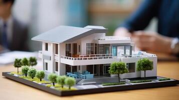 ai gerado miniatura modelo do uma casa em uma mesa dentro uma o negócio escritório foto