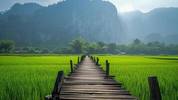 ai gerado panorama de madeira ponte em verde arroz campo e calcário montanha fundo foto