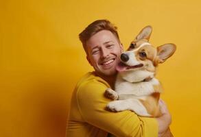 ai gerado uma alegre europeu homem é segurando e reconfortante a adorável corgi cachorro foto