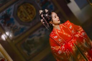 mulher vestir China Novo ano. retrato do uma mulher. pessoa dentro tradicional fantasia. mulher dentro tradicional fantasia. lindo jovem mulher dentro uma brilhante vermelho vestir e uma coroa do chinês rainha posando. foto