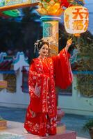 mulher vestir China Novo ano. retrato do uma mulher. pessoa dentro tradicional fantasia. mulher dentro tradicional fantasia. lindo jovem mulher dentro uma brilhante vermelho vestir e uma coroa do chinês rainha posando. foto