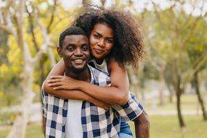 encontro casal homem e mulheres namorados dia. africano Preto amante às parque ao ar livre verão estação vintage cor tom foto