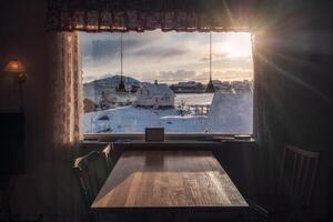 pôr do sol através em cortina com de madeira mesa foto
