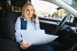 sério o negócio mulher dentro a carro examina importante documentos. foto