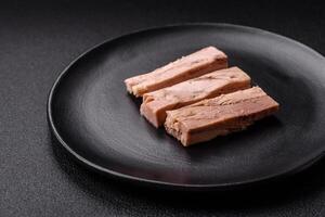 delicioso enlatado dietético atum carne com sal, especiarias e óleo foto