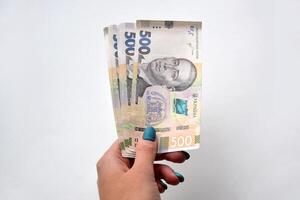 dentro a mãos do a Novo notas dentro denominações do 500 hryvnia foto