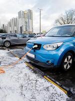 Minsk, bielorrússia, fevereiro 09, 2024 - elétrico carro kia cobrando em estacionamento foto