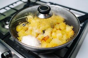 fritar batatas dentro uma panela com óleo, topo Visão foto