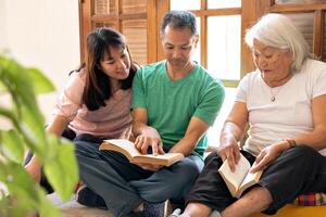 mãe e adulto crianças do japonês origem partilha uma momento do leitura. foto