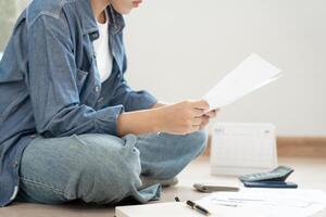 mulher estressada e com dor de cabeça com grandes contas ou faturas sem dinheiro para pagar despesas e dívidas de cartão de crédito. escassez, problema financeiro, falência, hipoteca, empréstimo, falido, pobre, carteira vazia foto