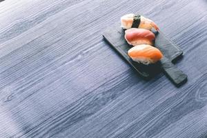 sushi na mesa de madeira. elegante restaurante japonês. Estilo retrô foto