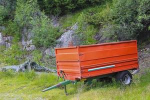 reboque de trator vermelho em um prado na noruega. foto