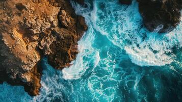 ai gerado espetacular zangão Visão captura a oceano onda falhando em uma rochoso penhasco, com uma pôr do sol horizonte pano de fundo. ai gerado. foto