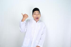 engraçado ásia muçulmano homem dando polegares acima com surpreso expressão isolado em branco fundo foto